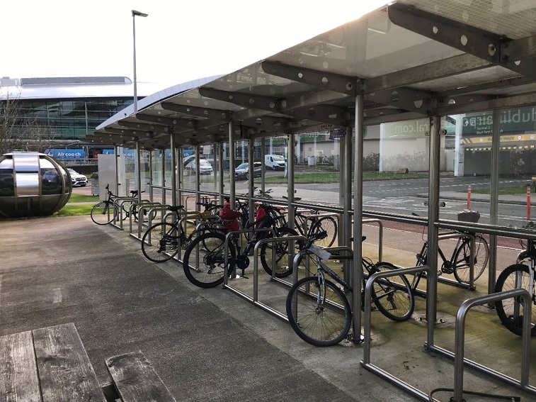 Opposite the T2 Multi Storey Car Park (with access to the terminal building through the car park entrance and pedestrian bridge)